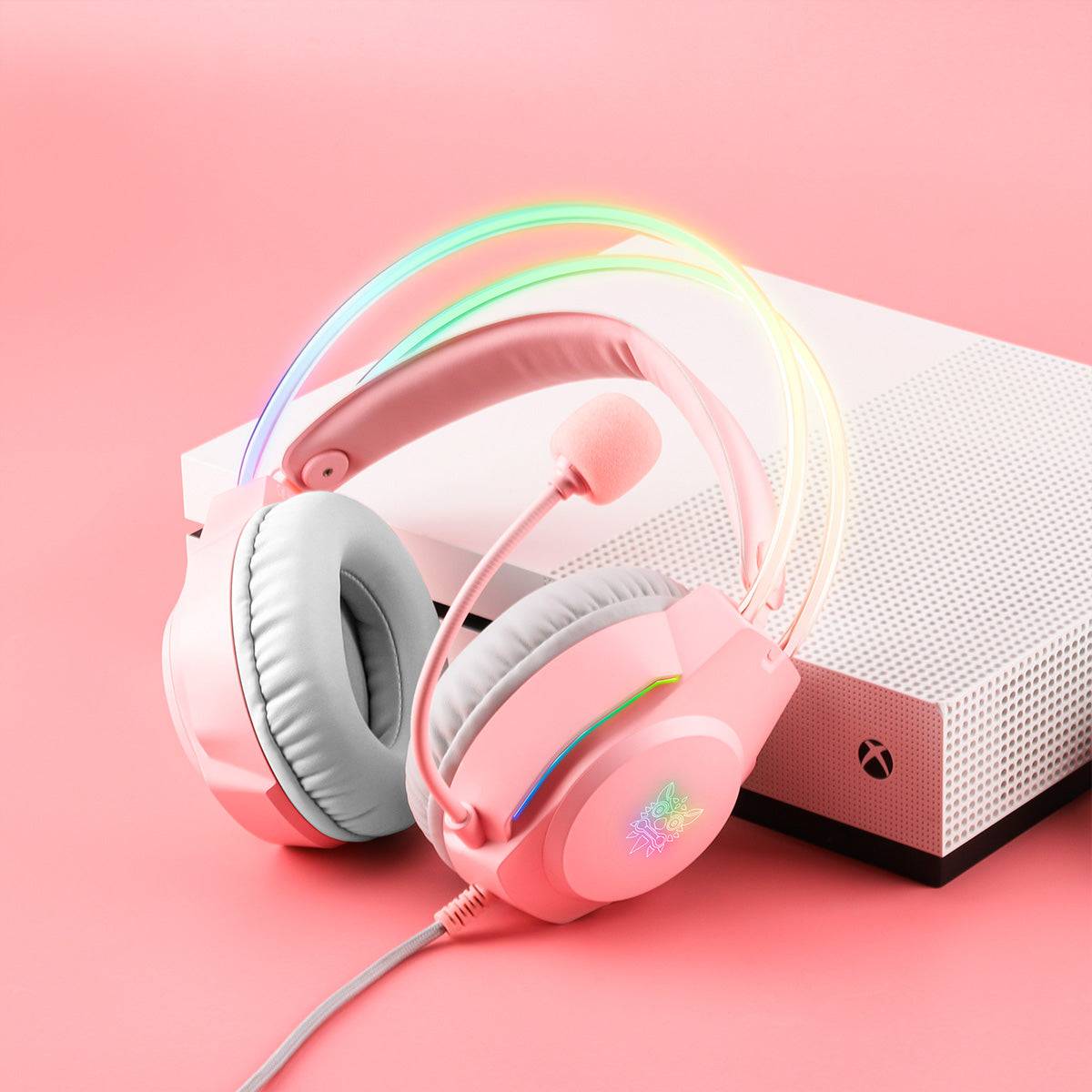 ONIKUMA X26 Cat Ear RGB Gaming Headset placed next to a white Xbox console, highlighting its stylish pink design and compatibility with multiple devices.